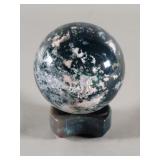 Polished sage agate sphere with a moss agate stand