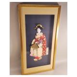Framed Japanese fabric art geisha holding a