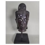 Brass Buddha head sculpture on a wood stand
