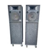2 large Sound Pacific Inc. speakers on wheels