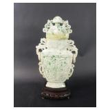 Carved jadeite urn sculpture on a wooden base