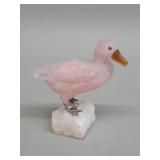 Carved rose quartz duck figure mounted on a