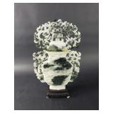 Carved jadeite urn sculpture on a wooden base