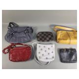 Group of women's designer style handbags