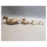 Four brass duck figurines