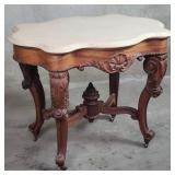 Antique carved walnut center table on casters