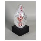 Hand blown glass paperweight on a glass base