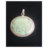 Oval green turquoise gemstone pendant set in a