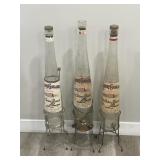 3 large liquor Galliano empty bottles with stand