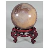 Agate sphere on a wood base