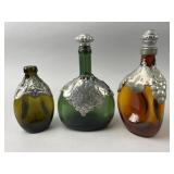 Three Glass Bottles with Pewter Decoration