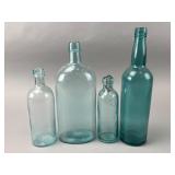 Four Clear and Aqua Glass Bottles