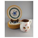 Six Floral Plates and Decorated Creamer