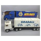 A Pair of Nylint NAPA and Gradall Toy Semi Trucks