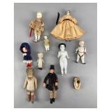 Ten small dolls made from a variety of materials.