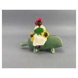 McCoy Ceramic Figurine of Person on Green Object