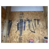 6 saws, 2 hammers on back wall