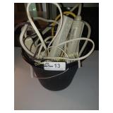 Bucket full of Misc. etension cords/surge