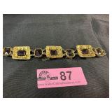 Antique style gold-tone panel bracelet with ornate