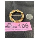 Vintage gold-tone circular wreath brooch adorned