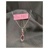Elegant silver tone pendant and necklace featuring