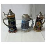 Collectible beer steins with pewter lids.