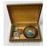 Cigar box with matches and ash tray.