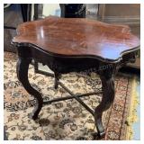 antique mahogany table features a carved "turtle