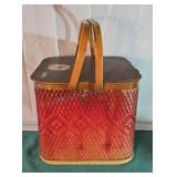 Mid-century picnic basket with metal handles.