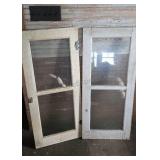 Framed cabinet doors with glass inserts. Each is