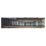 Canning and preserving jars on one shelf.
