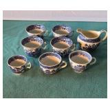 Assorted vintage blue cups and creamer.