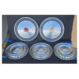 Assorted Pontiac hubcaps.