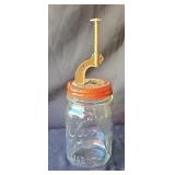 Vintage cherry pitter screwed on to a Kerr jar.