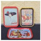 Metal Coca-Cola trays.