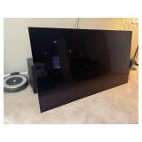 LG 64" television, remote control