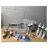 Tote of consumables, caulk, adhesives