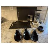 Black cutting boards, spoon rests, grater, egg &