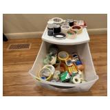 Plastic storage tote of tape, adhesives