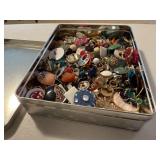 Tin of assorted earrings