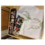 Embroidered linens, wooden spools of thread