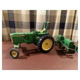 John Deere toy tractor, implement