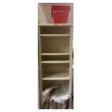 Tall plastic shelf with baskets and packaging