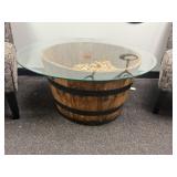 1/2 whiskey barrel table filled with corks, with