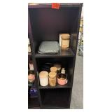 Black shelf with candles and bag