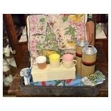Suitcase, linens, thermos, cups