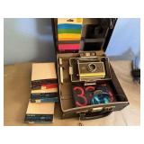 Polaroid instamatic camera, film, carry case