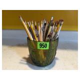 Green vase of pencils