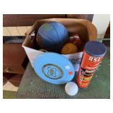 Box of balls, frisbee, basketball, tennis balls