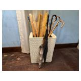 Hamper of yard sticks, umbrellas